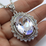 best quality, 4k, best lighting, best shadows, intricate details, silver filigree oval-shaped pendant with clear quartz crystal gem navette cut, front view, direct center