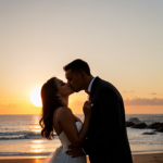 A man and woman kissing with a sunset