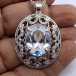 best quality, 4k, best lighting, best shadows, intricate details, silver filigree oval-shaped pendant with clear quartz crystal gem navette cut, front view, direct center