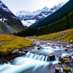 Picture of snow capped mountains with a stream