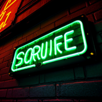 a fluresent neon sign in a dark ally way that reads “Secure 366”